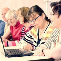 Older people learning on laptop